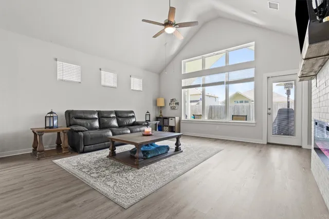 a living room with furniture and a floor to ceiling window
