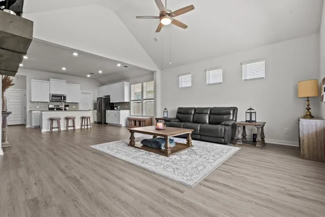 a living room with furniture and kitchen view