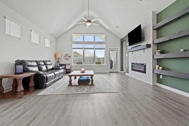 a living room with furniture and a fireplace