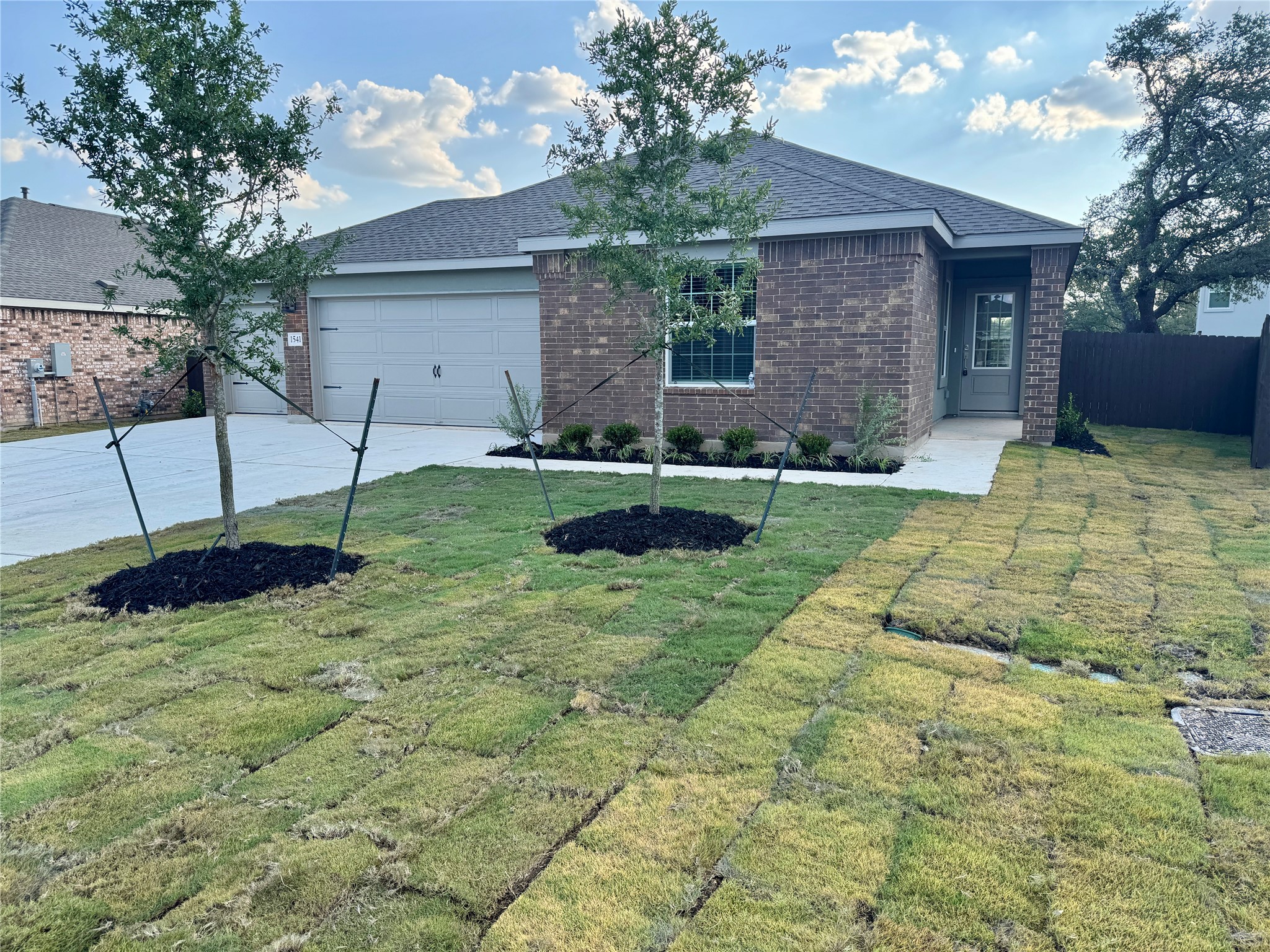 1541 Boggy Crk Rnch Road Georgetown, TX 78628 - Photo 1 of 30 Ranch-style house with brick siding, concrete driveway, a shingled roof, and an attached garage