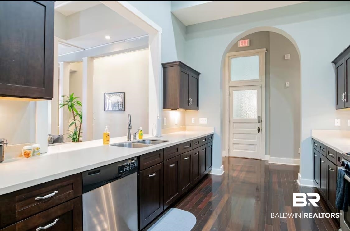 204 Conti Street, Unit 1C Mobile, AL 36602 - Photo 2 of 12 Kitchen with stainless steel appliances, dark wood-type flooring, dark brown cabinetry, light stone countertops, and recessed lighting