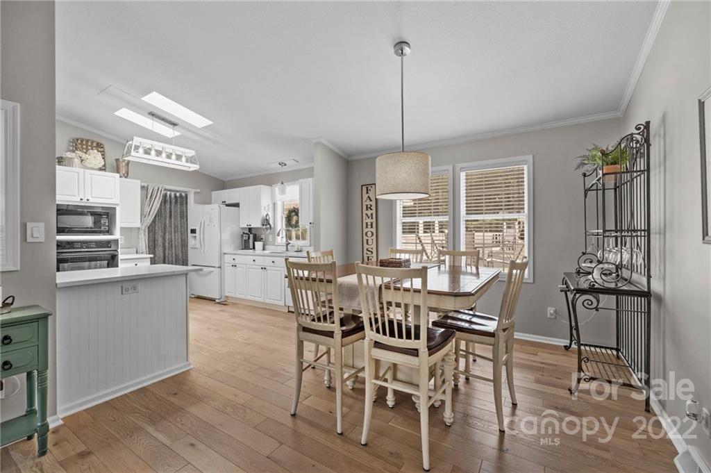 11008 Asbury Chapel Road Huntersville, NC 28078 - Photo 13 of 45 a view of a dining room with furniture window and wooden floor