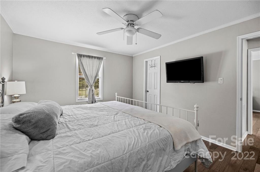 11008 Asbury Chapel Road Huntersville, NC 28078 - Photo 24 of 45 a bedroom with a bed tv and a window