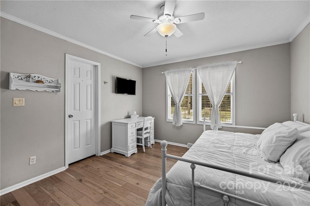 11008 Asbury Chapel Road Huntersville, NC 28078 - Photo 26 of 45 a bedroom with a bed window and a flat screen tv