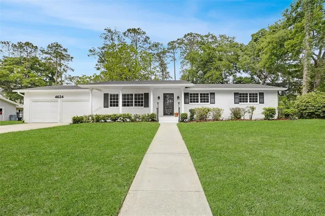 a view of house with a yard