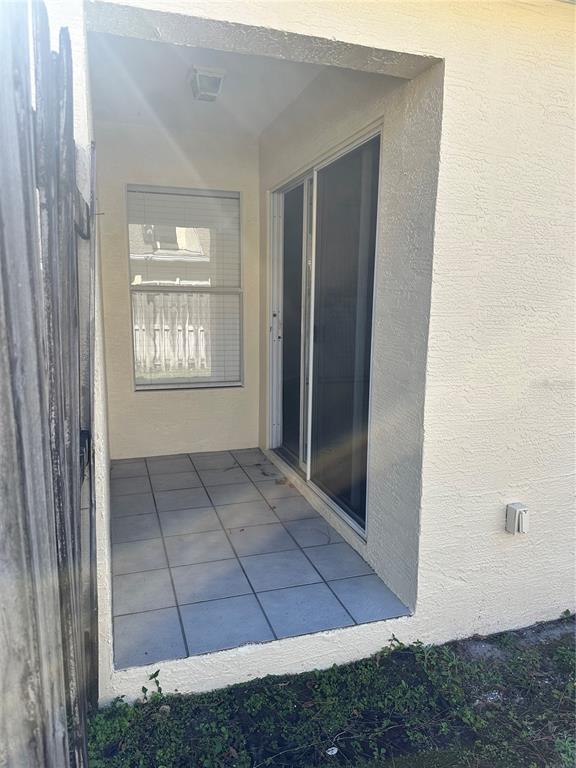 658 Green Valley Road, Unit B3 Palm Harbor, FL 34683 - Photo 13 of 24 a view of an empty room with windows and chandelier