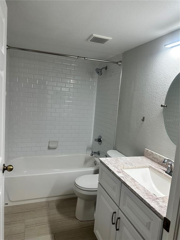 658 Green Valley Road, Unit B3 Palm Harbor, FL 34683 - Photo 14 of 24 a bathroom with a granite countertop sink a toilet and shower