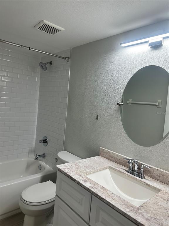 658 Green Valley Road, Unit B3 Palm Harbor, FL 34683 - Photo 15 of 24 a bathroom with a granite countertop toilet sink and mirror