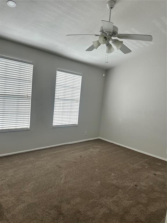 658 Green Valley Road, Unit B3 Palm Harbor, FL 34683 - Photo 19 of 24 an empty room with windows and fan