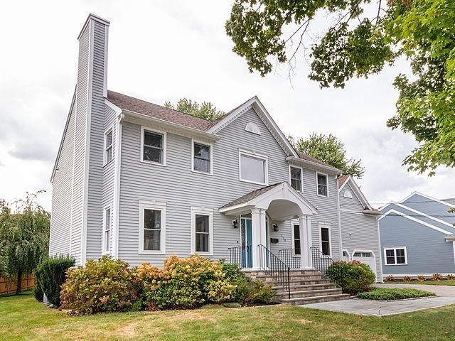 120 Hanson Road Newton, MA 02459 - Photo 1 of 33 a front view of a house with a garden