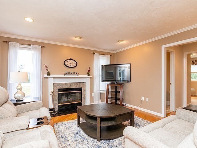 120 Hanson Road Newton, MA 02459 - Photo 11 of 33 a living room with furniture a fireplace and a flat screen tv