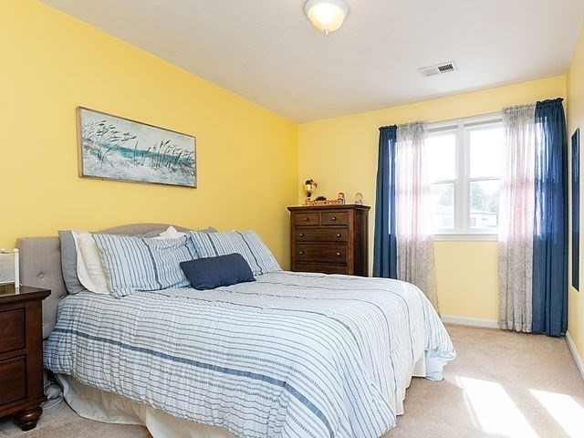 120 Hanson Road Newton, MA 02459 - Photo 18 of 33 a bedroom with a bed and wooden floor