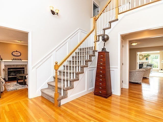 120 Hanson Road Newton, MA 02459 - Photo 2 of 33 a view of an entryway with wooden floor and a fireplace