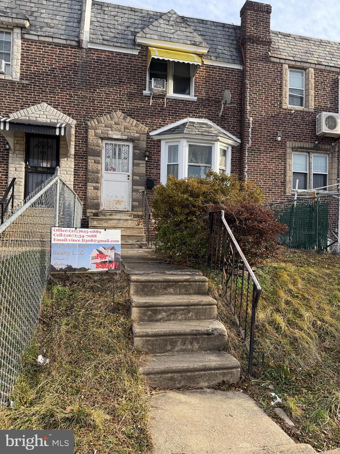 a front view of a house with stairs