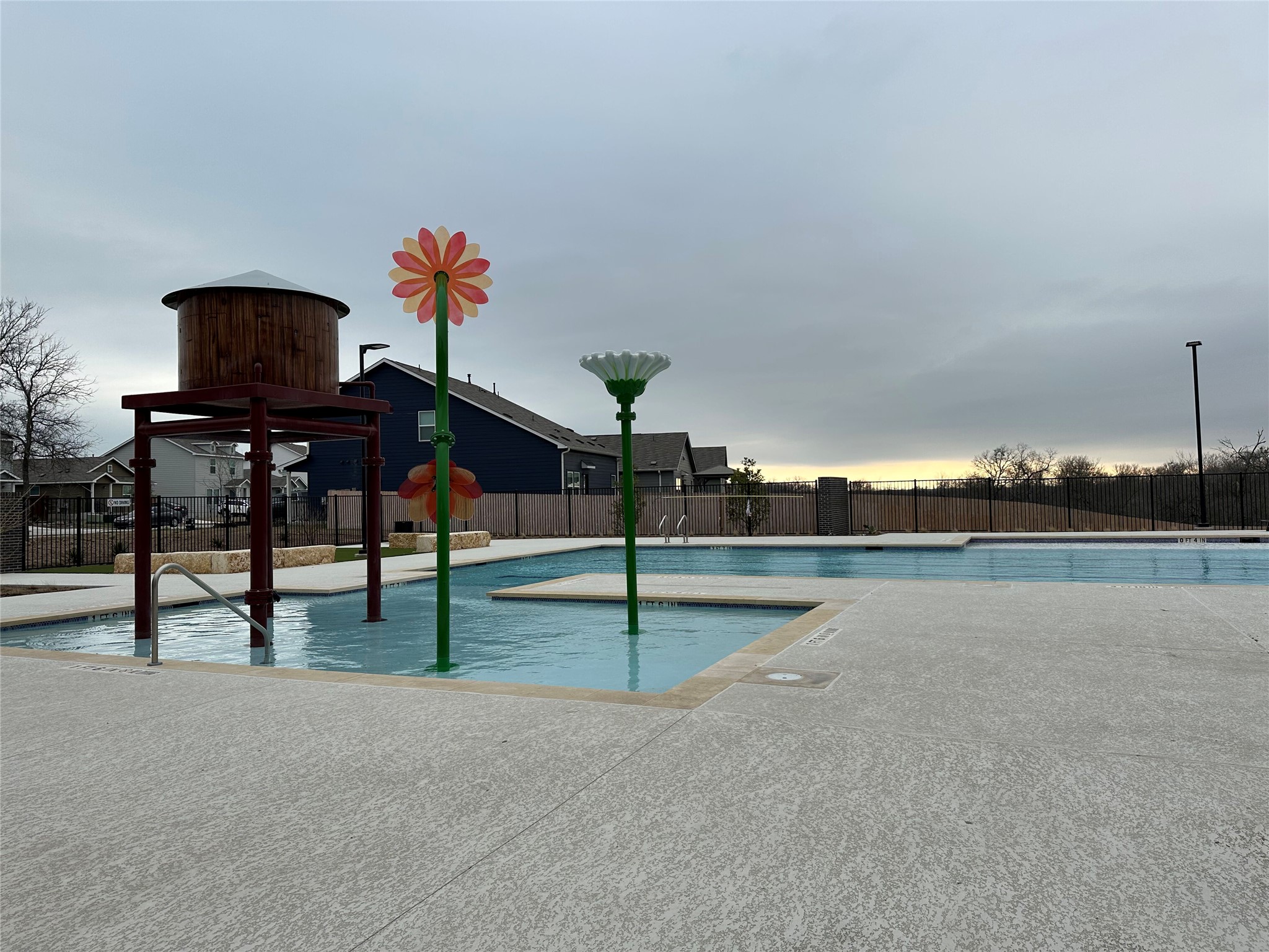 13501 Mussel Run Elgin, TX 78621 - Photo 26 of 28 Community swimming pool featuring a splash pad with water tower structure and decorative flower sprayers