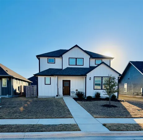 a kitchen with stainless steel appliances granite countertop a refrigerator a stove a sink dishwasher and white cabinets with wooden floor