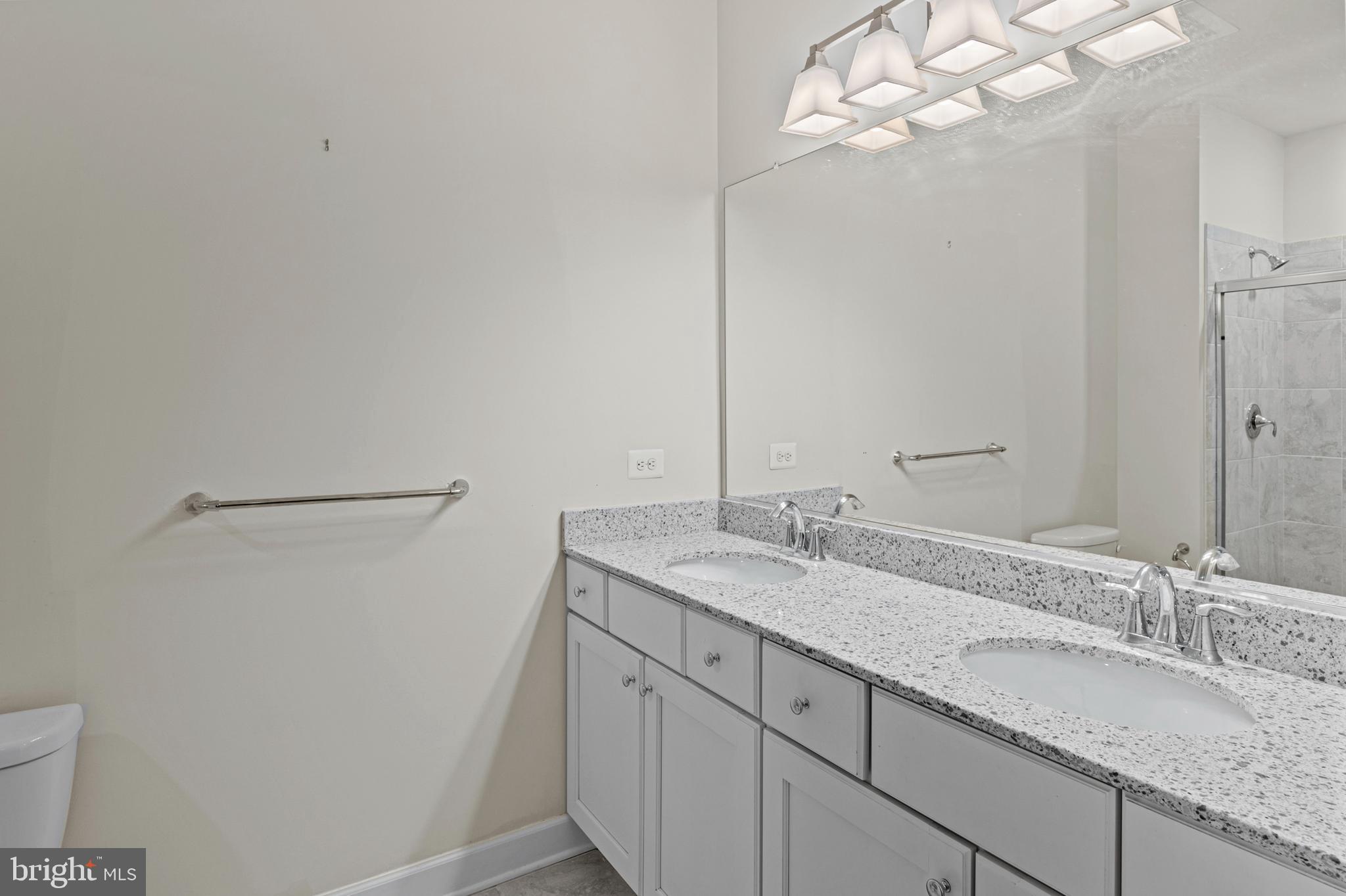 10530 Resort Road, Unit 110 Ellicott City, MD 21042 - Photo 14 of 21 a bathroom with a granite countertop sink and a mirror