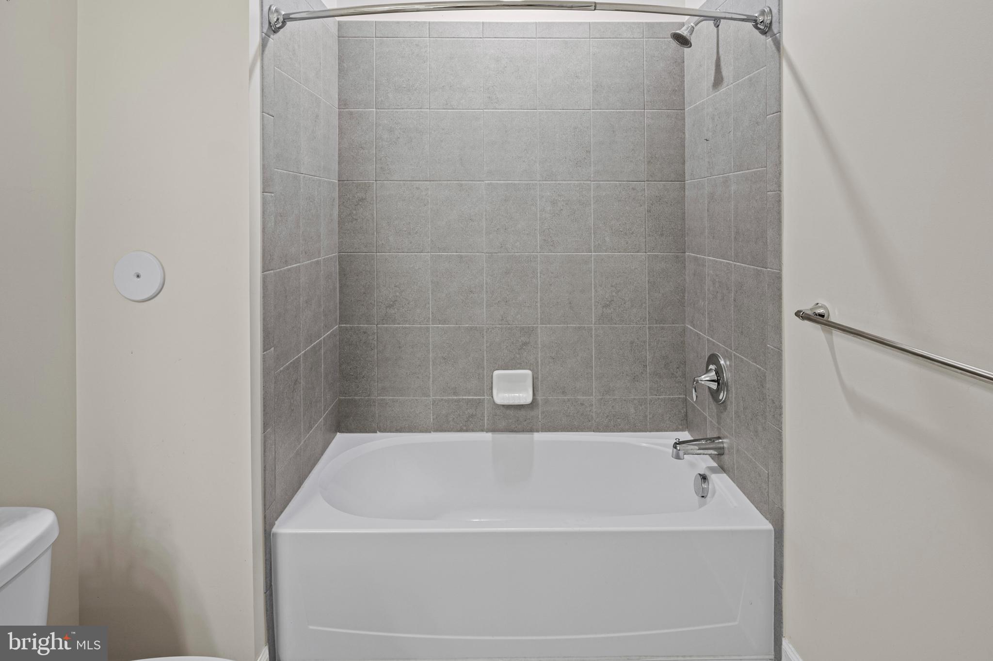 10530 Resort Road, Unit 110 Ellicott City, MD 21042 - Photo 19 of 21 a bath tub sitting next to a white toilet