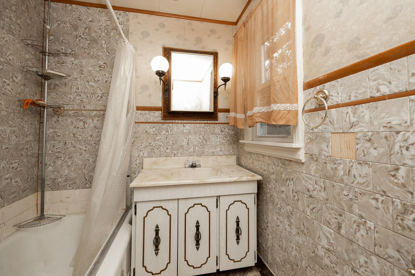 706 Clinton Street Lockport, IL 60441 - Photo 11 of 12 a bathroom with a sink and a mirror