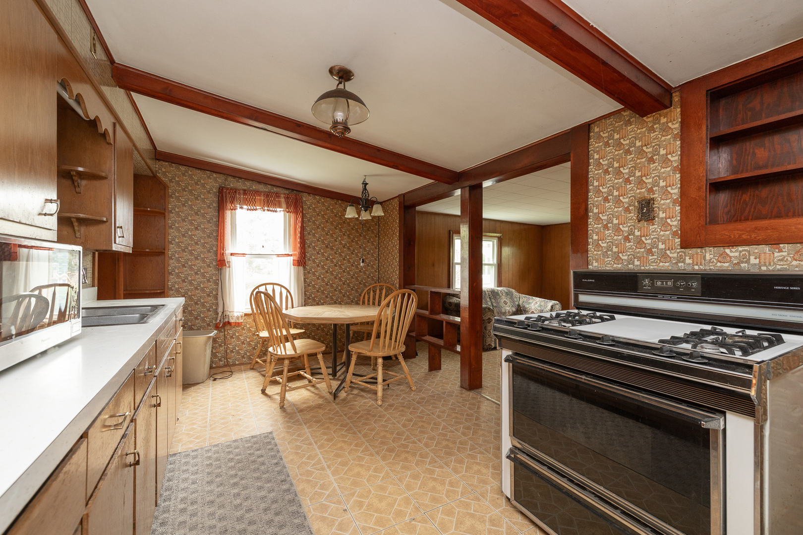 706 Clinton Street Lockport, IL 60441 - Photo 6 of 12 a kitchen with a stove and a microwave