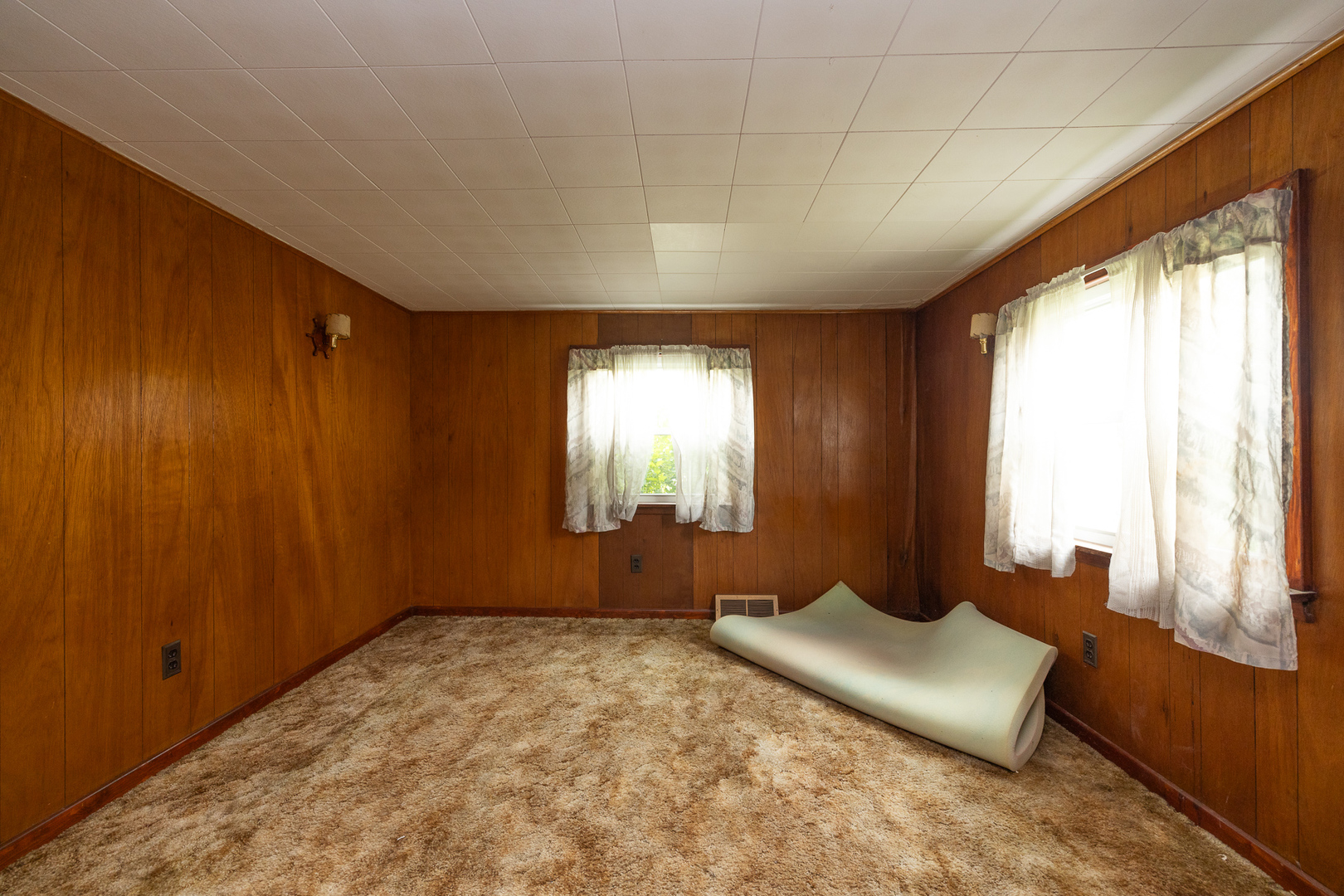 706 Clinton Street Lockport, IL 60441 - Photo 9 of 12 a spacious bedroom with a bed and large windows
