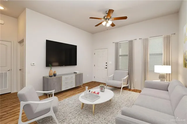 a living room with furniture and a flat screen tv