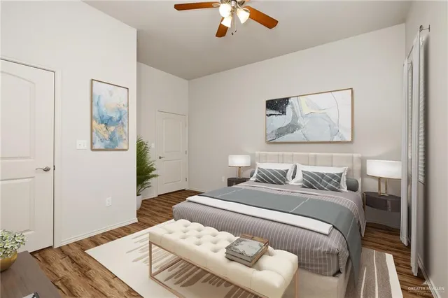 a bedroom with a large bed and a chandelier