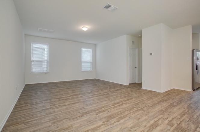 148 Spotted Rail Ridge Leander, TX 78641 - Photo 4 of 31 Natural light filters through ample windows, illuminating the spacious living area.