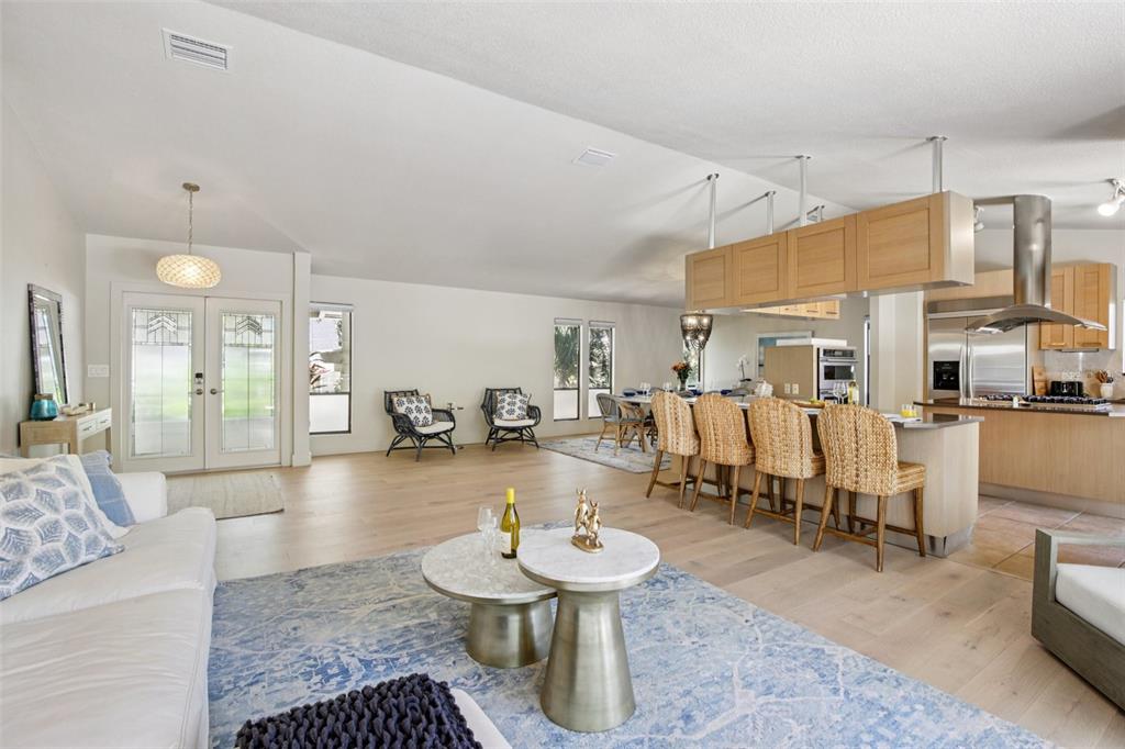 3390 Bayou Sound Longboat Key, FL 34228 - Photo 17 of 59 a living room with lots of furniture and kitchen view