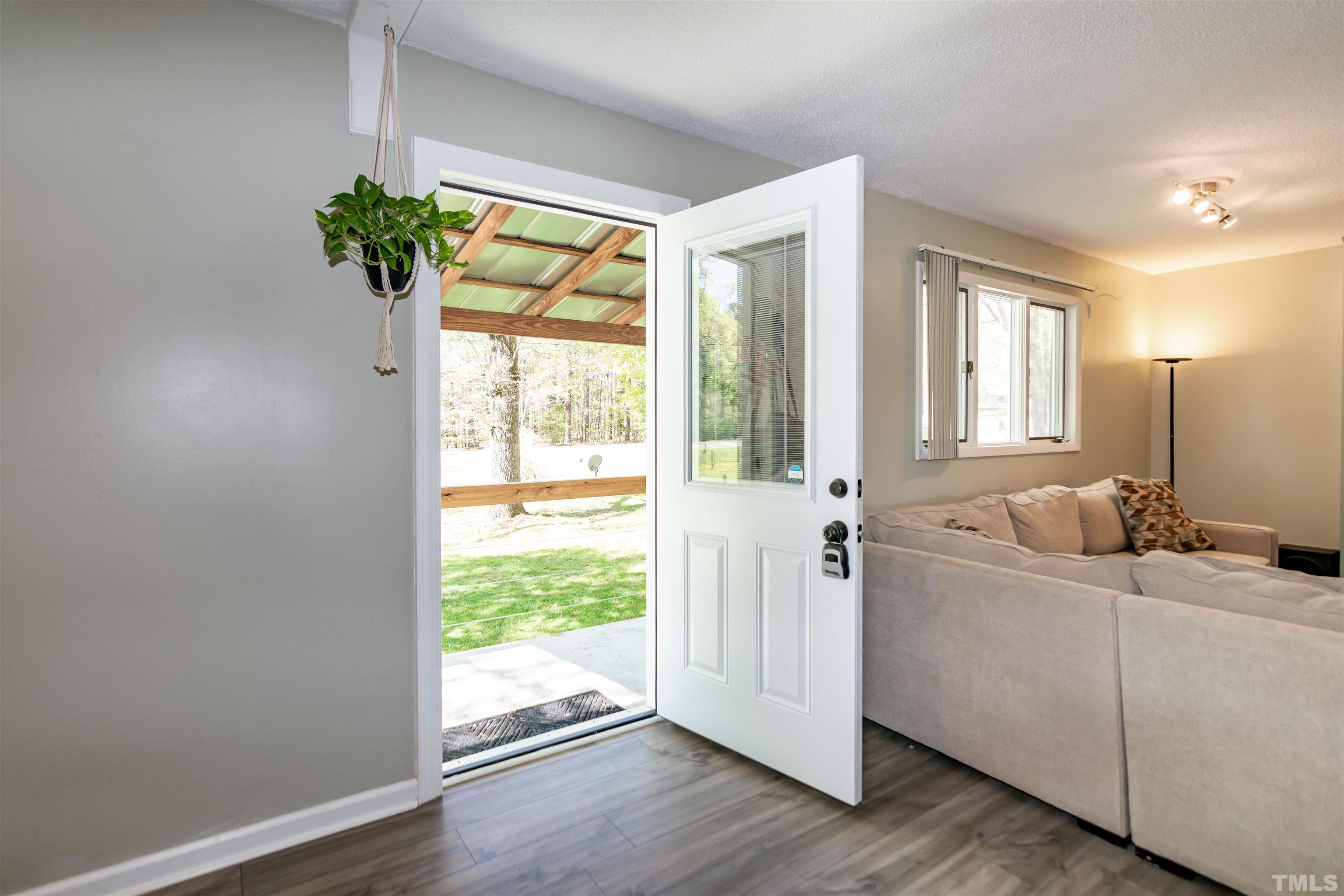 804 Stallings Road Durham, NC 27703 - Photo 12 of 37 a living room with a large window and wooden floor
