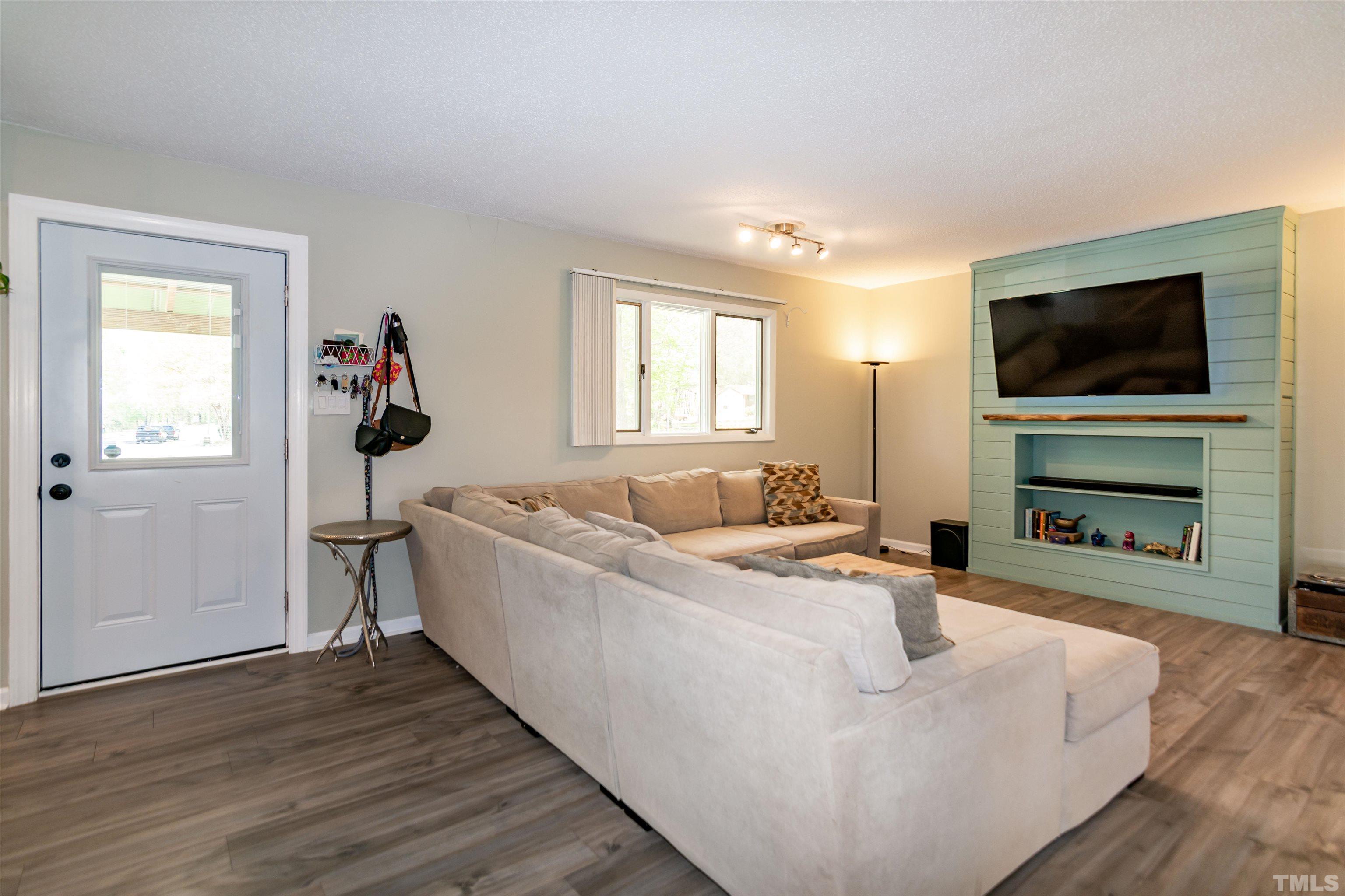 804 Stallings Road Durham, NC 27703 - Photo 13 of 37 a living room with furniture and a flat screen tv