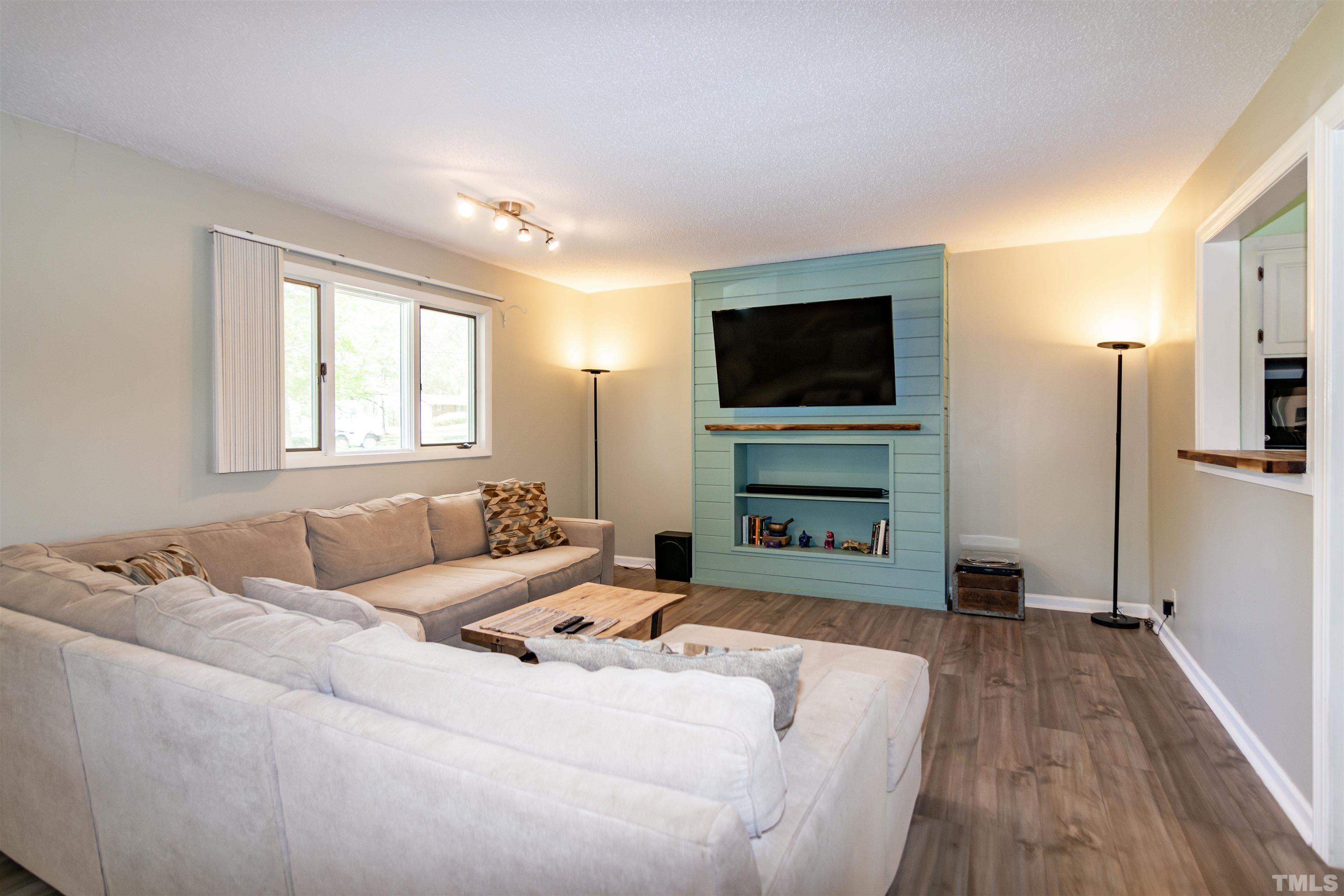 804 Stallings Road Durham, NC 27703 - Photo 14 of 37 a living room with furniture and a flat screen tv