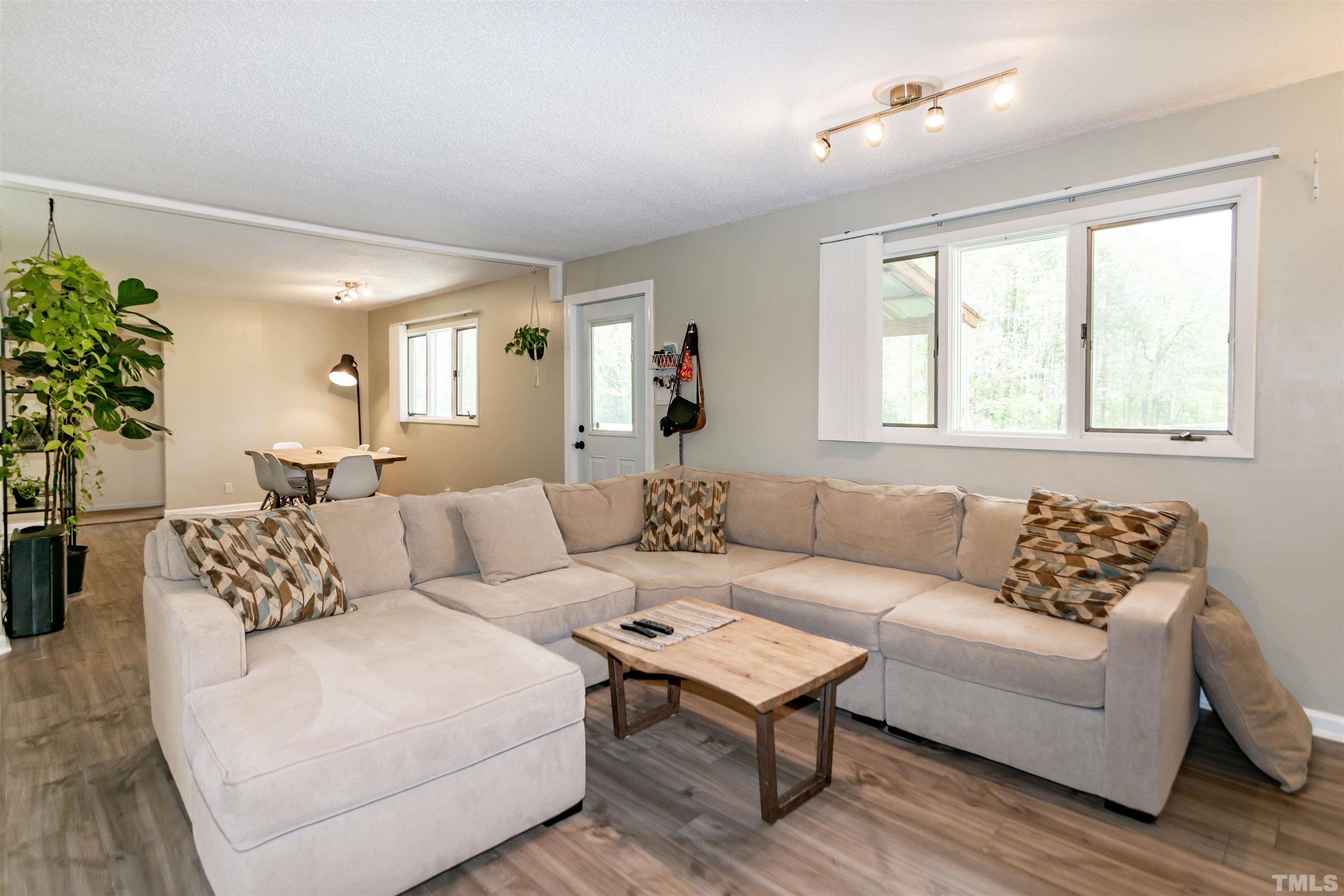 804 Stallings Road Durham, NC 27703 - Photo 16 of 37 a living room with furniture and a large window