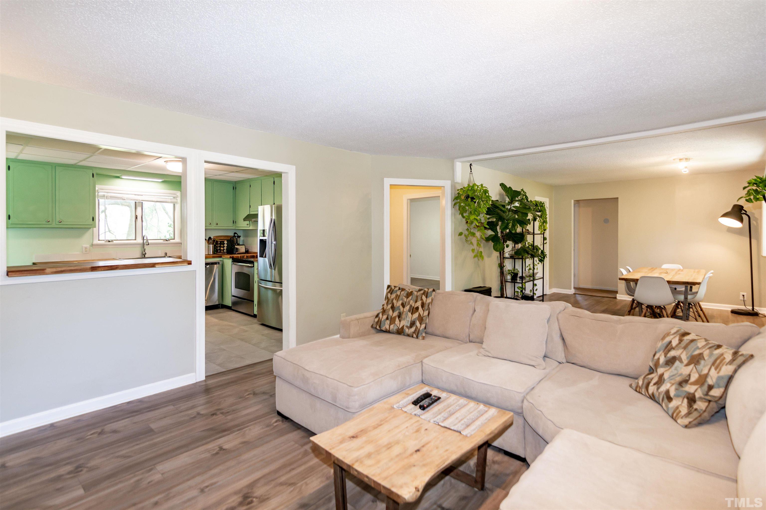 804 Stallings Road Durham, NC 27703 - Photo 17 of 37 a living room with furniture and a wooden floor