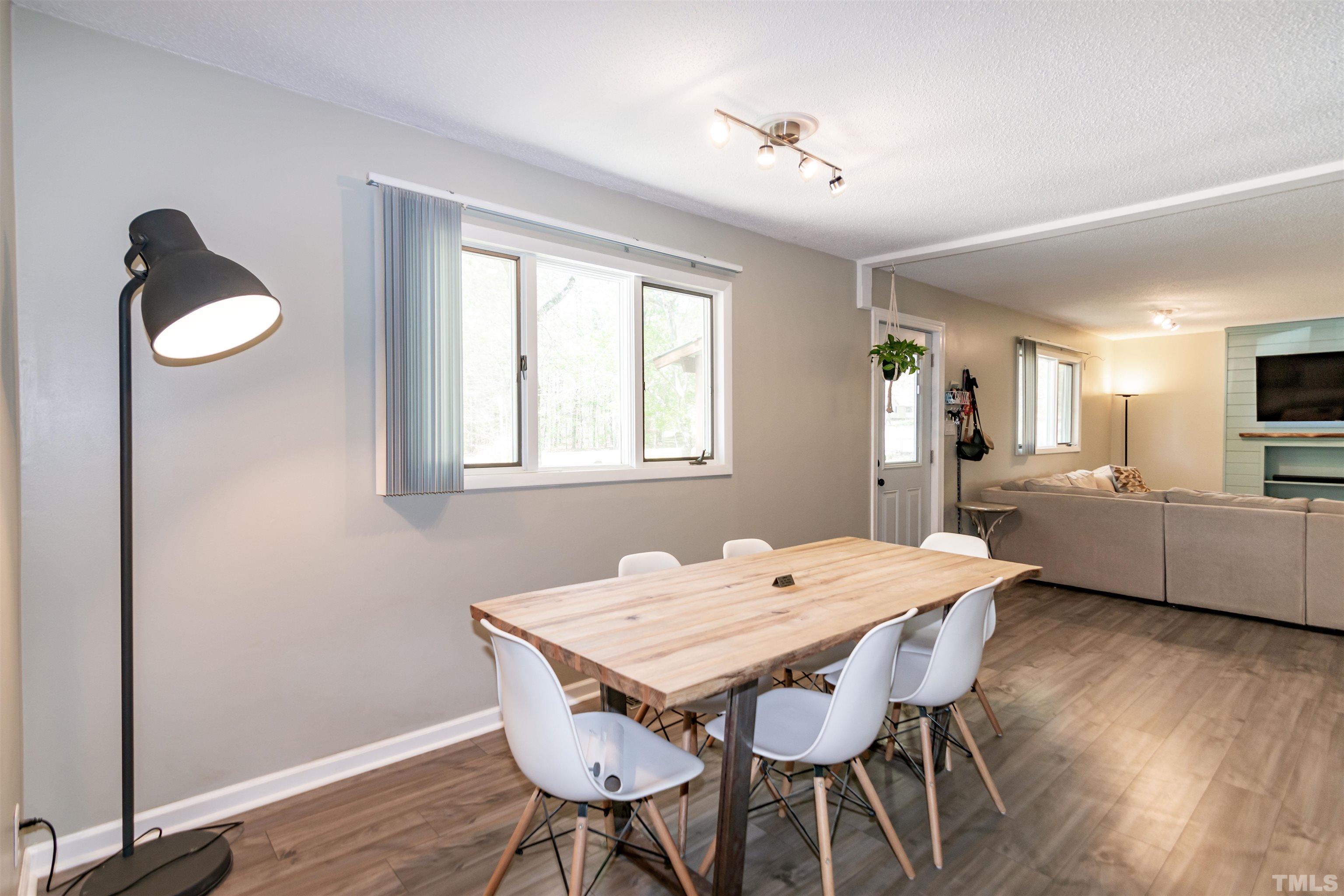 804 Stallings Road Durham, NC 27703 - Photo 20 of 37 a view of a dining room with furniture window and wooden floor