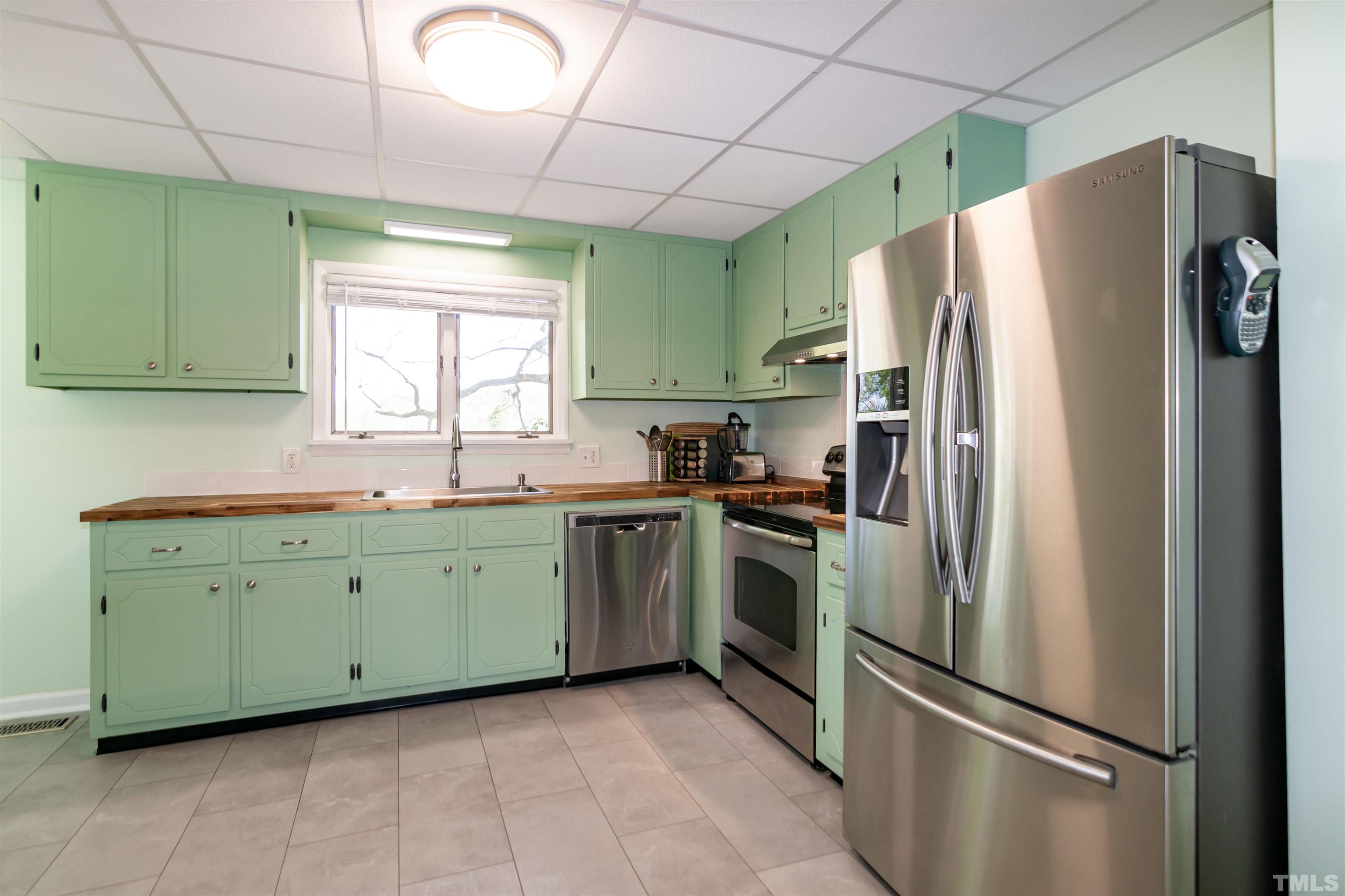 804 Stallings Road Durham, NC 27703 - Photo 21 of 37 a kitchen with stainless steel appliances granite countertop a refrigerator and a sink