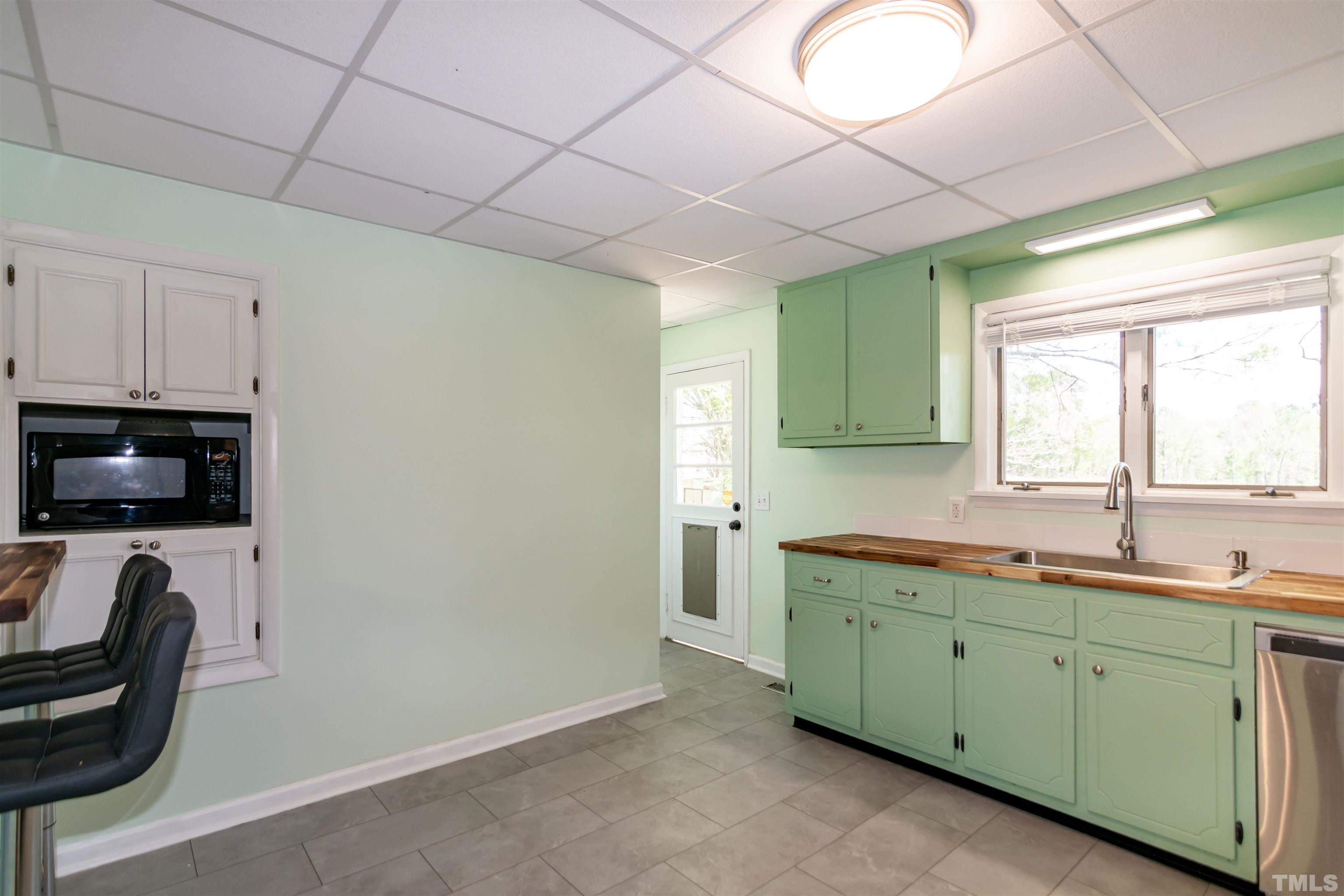 804 Stallings Road Durham, NC 27703 - Photo 22 of 37 a kitchen with a sink and a microwave