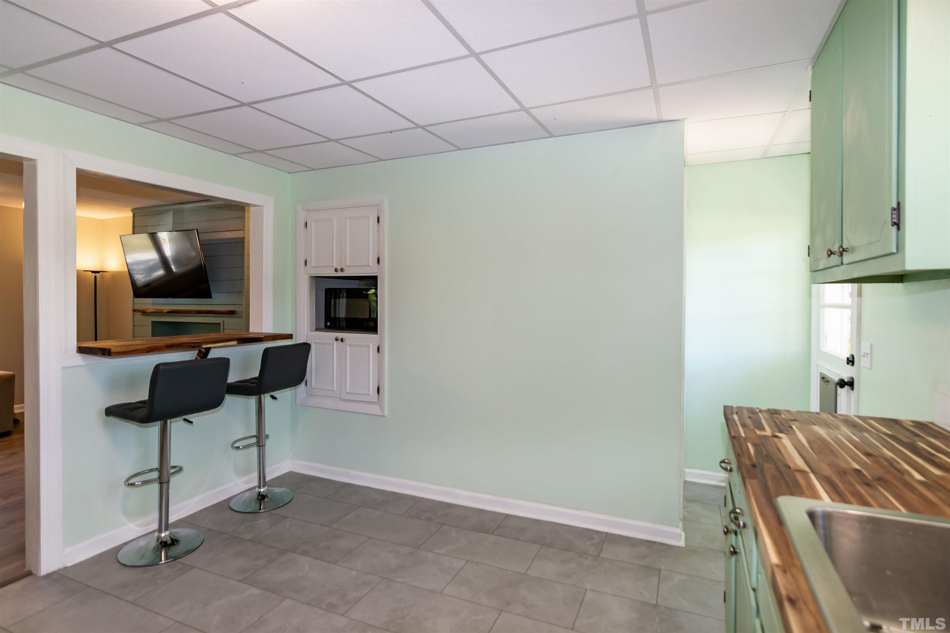 804 Stallings Road Durham, NC 27703 - Photo 23 of 37 a living room with furniture and a flat screen tv