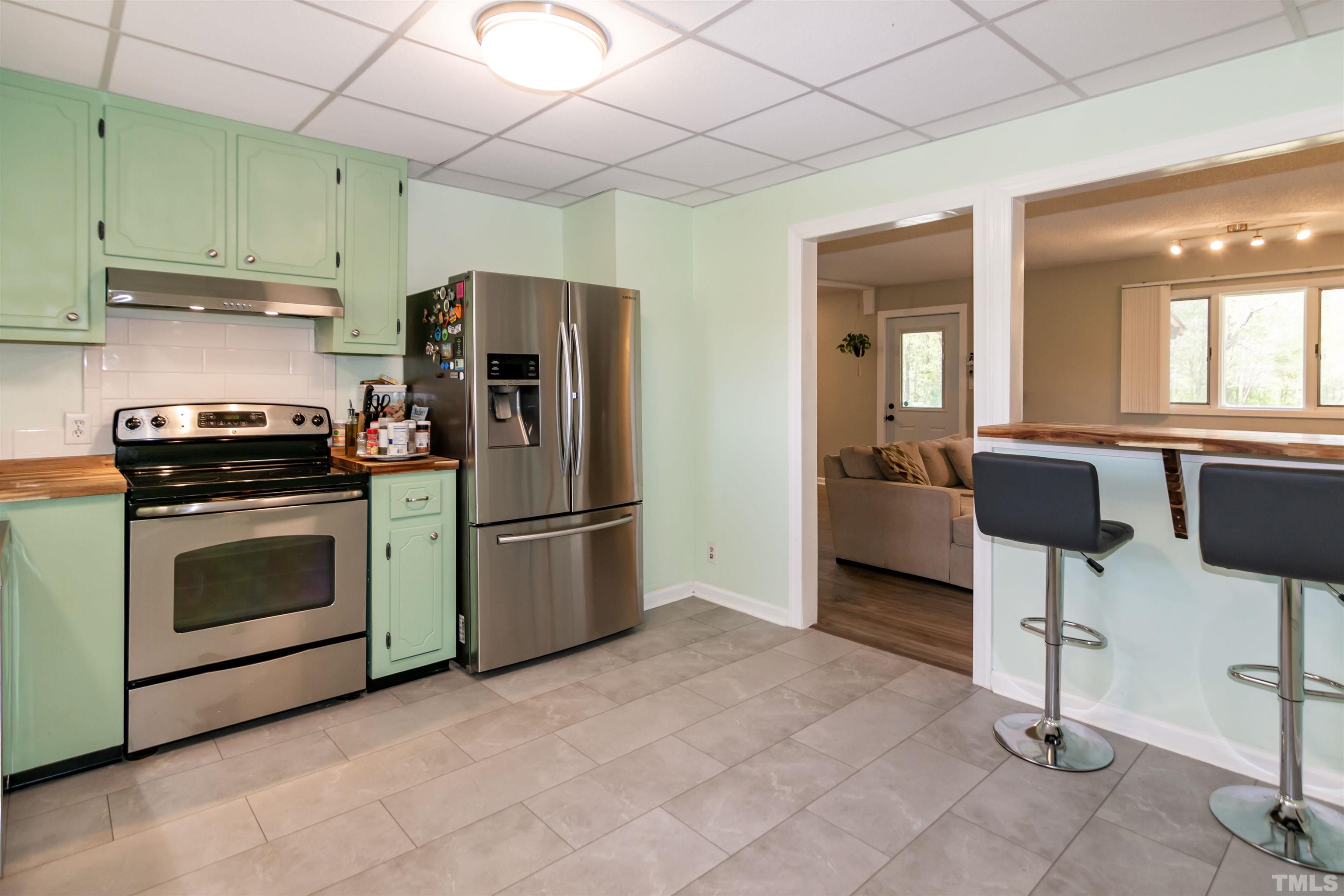 804 Stallings Road Durham, NC 27703 - Photo 24 of 37 a kitchen with stainless steel appliances a stove a refrigerator and a sink