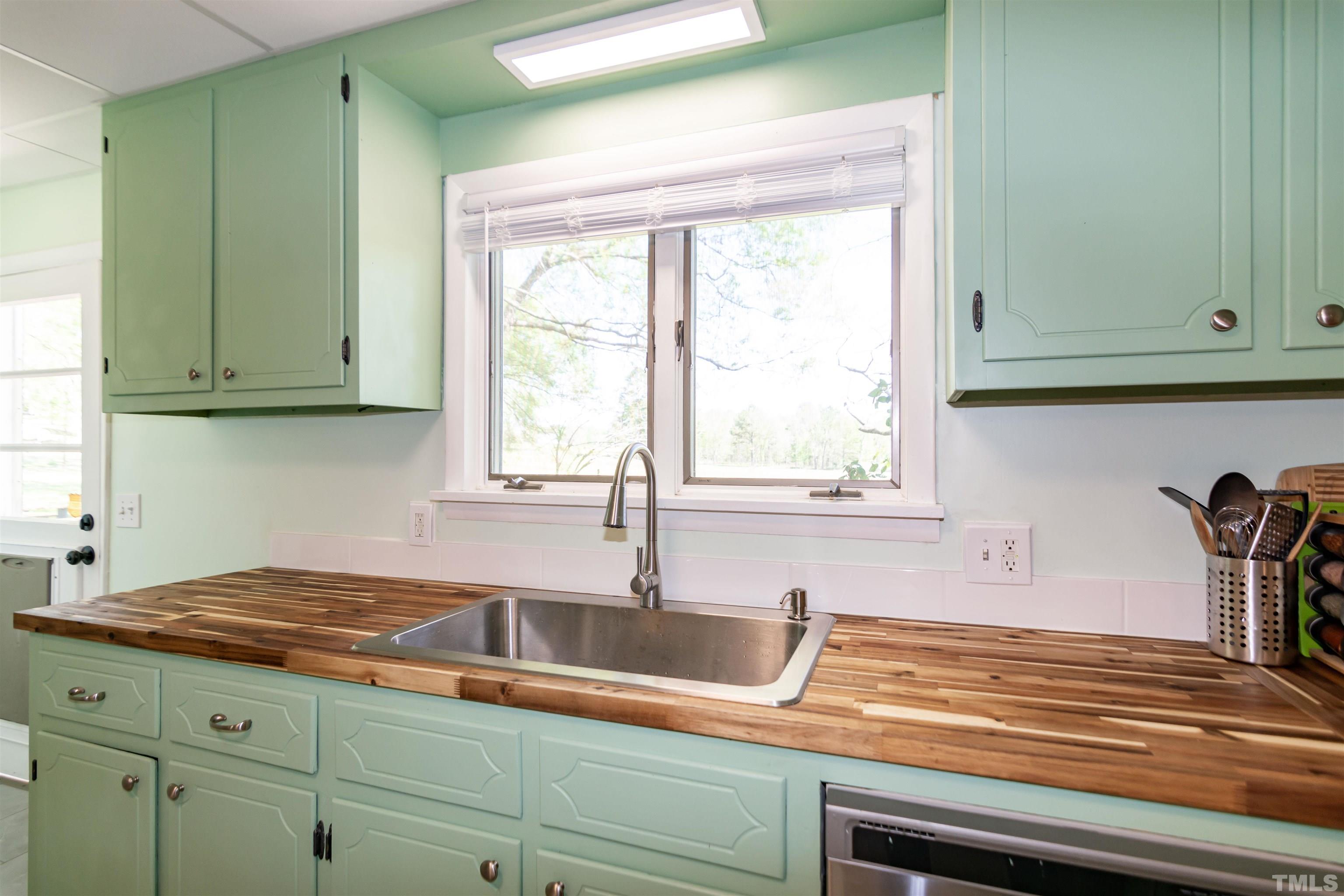 804 Stallings Road Durham, NC 27703 - Photo 26 of 37 a kitchen with a sink cabinets and a window