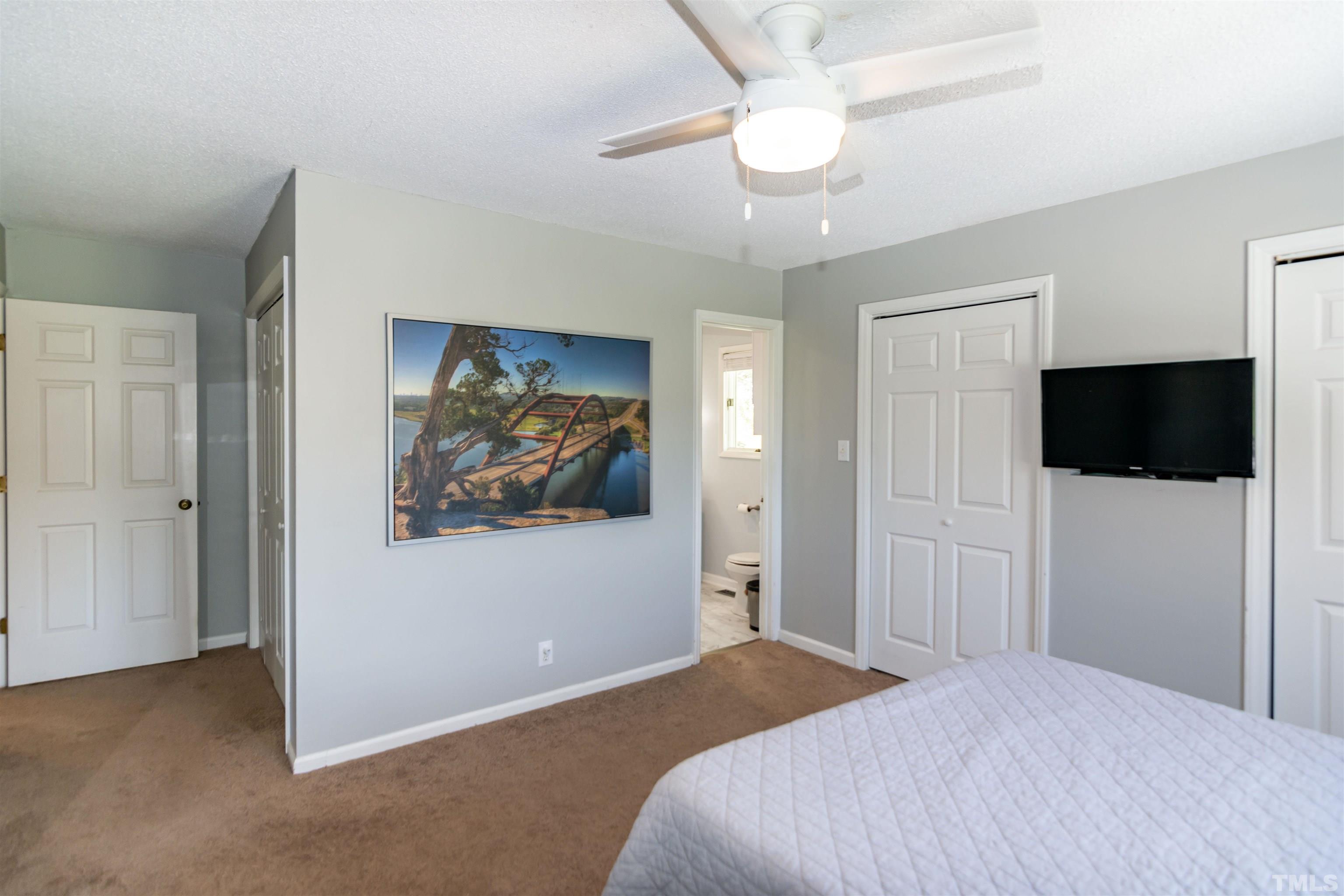 804 Stallings Road Durham, NC 27703 - Photo 35 of 37 a bedroom with a bed and a flat screen tv