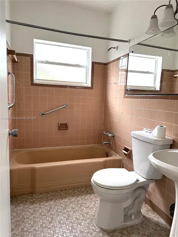 a bathroom with a toilet a sink and a bathtub