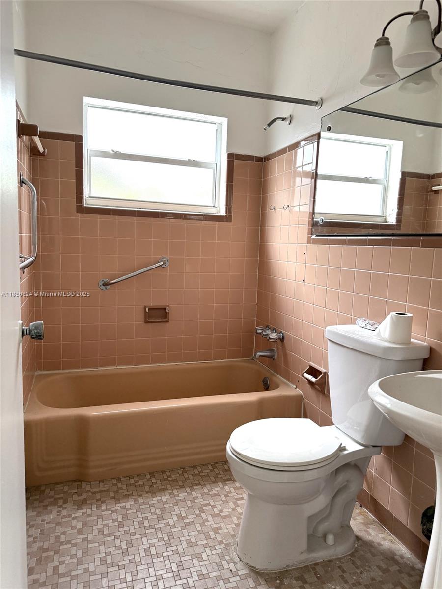 1788 Southwest 7th Street, Unit 4 Miami, FL 33135 - Photo 2 of 9 a bathroom with a toilet a sink and a bathtub