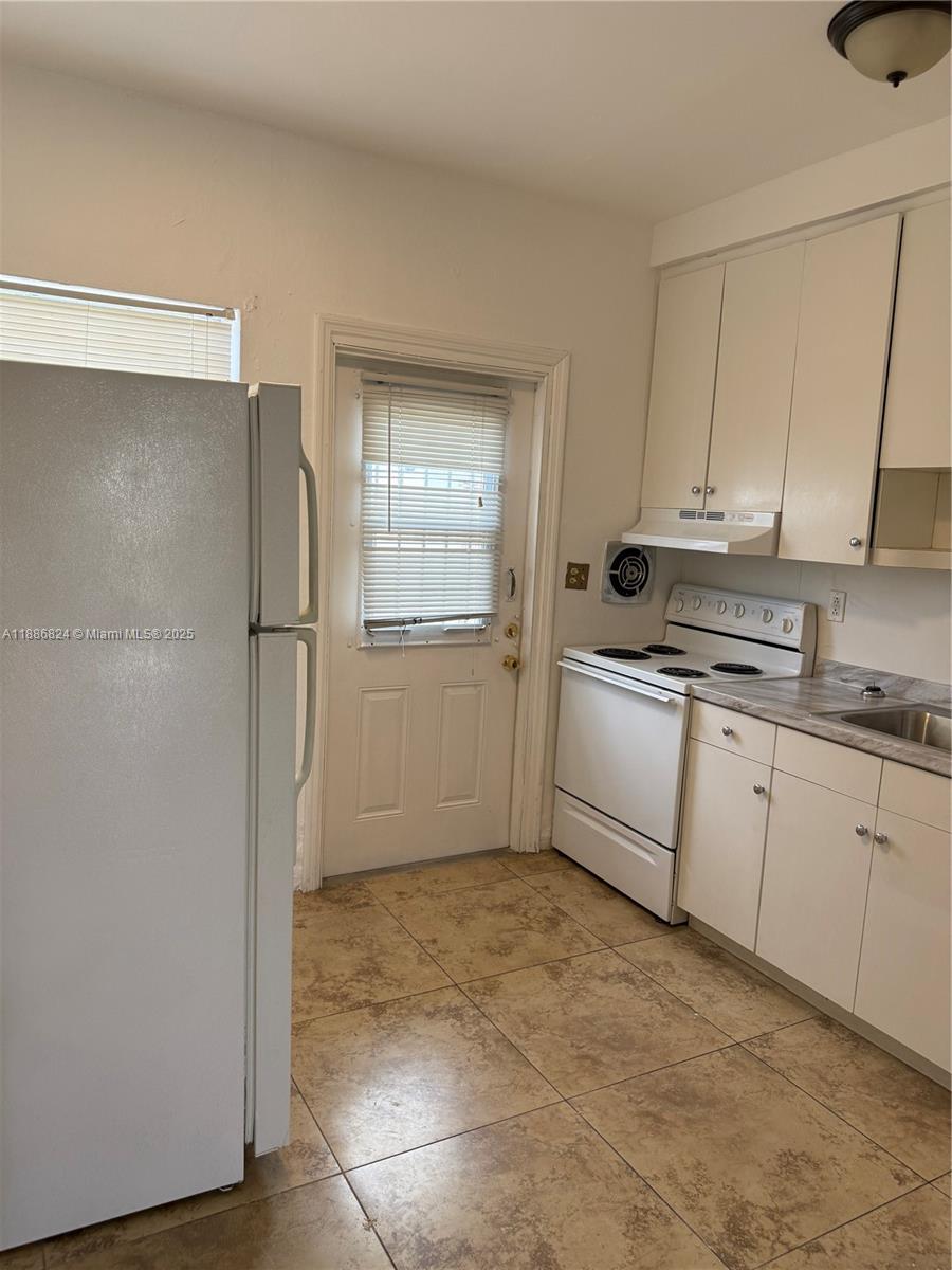 1788 Southwest 7th Street, Unit 4 Miami, FL 33135 - Photo 9 of 9 a kitchen with a refrigerator sink and cabinets