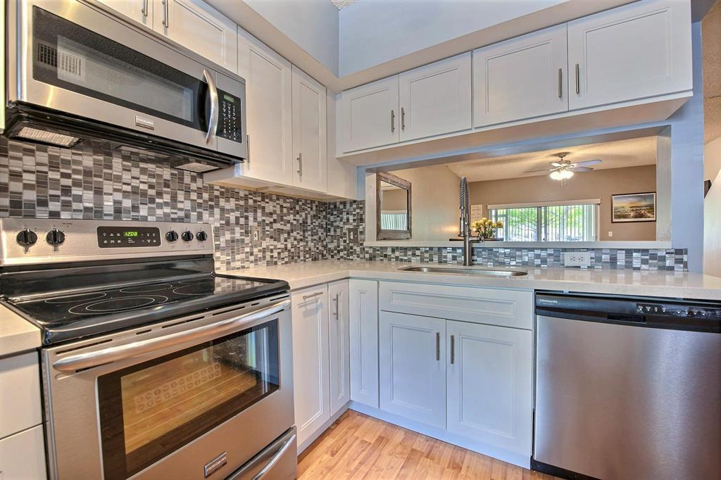 154 Southwest 96th Terrace Plantation, FL 33324 - Photo 6 of 12 a kitchen with cabinets appliances and a sink