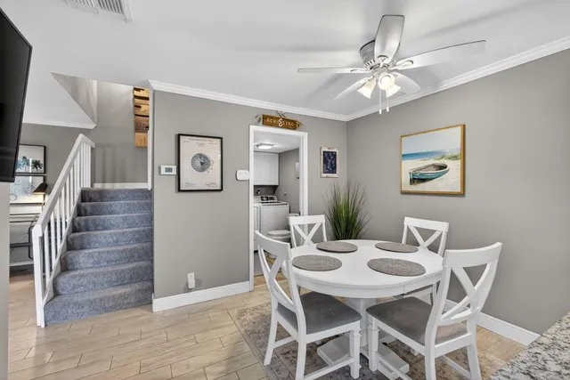a living room with furniture and a flat screen tv with wooden floor