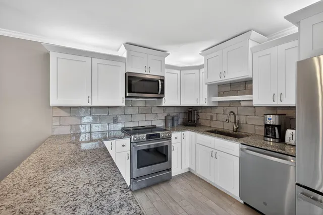 a living room with furniture a flat screen tv and a large window