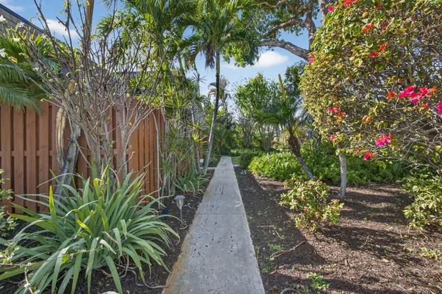 a view of a dining room with furniture and a chandelier fan