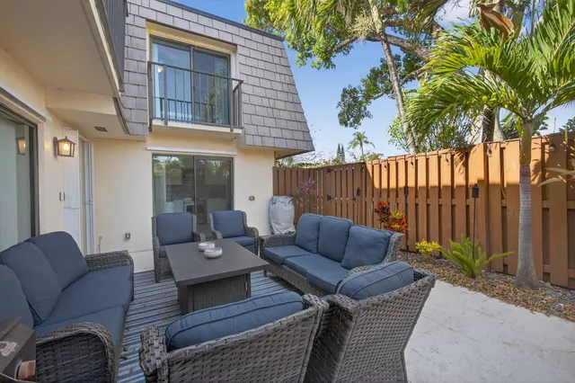 a bathroom with a granite countertop sink a mirror and shower