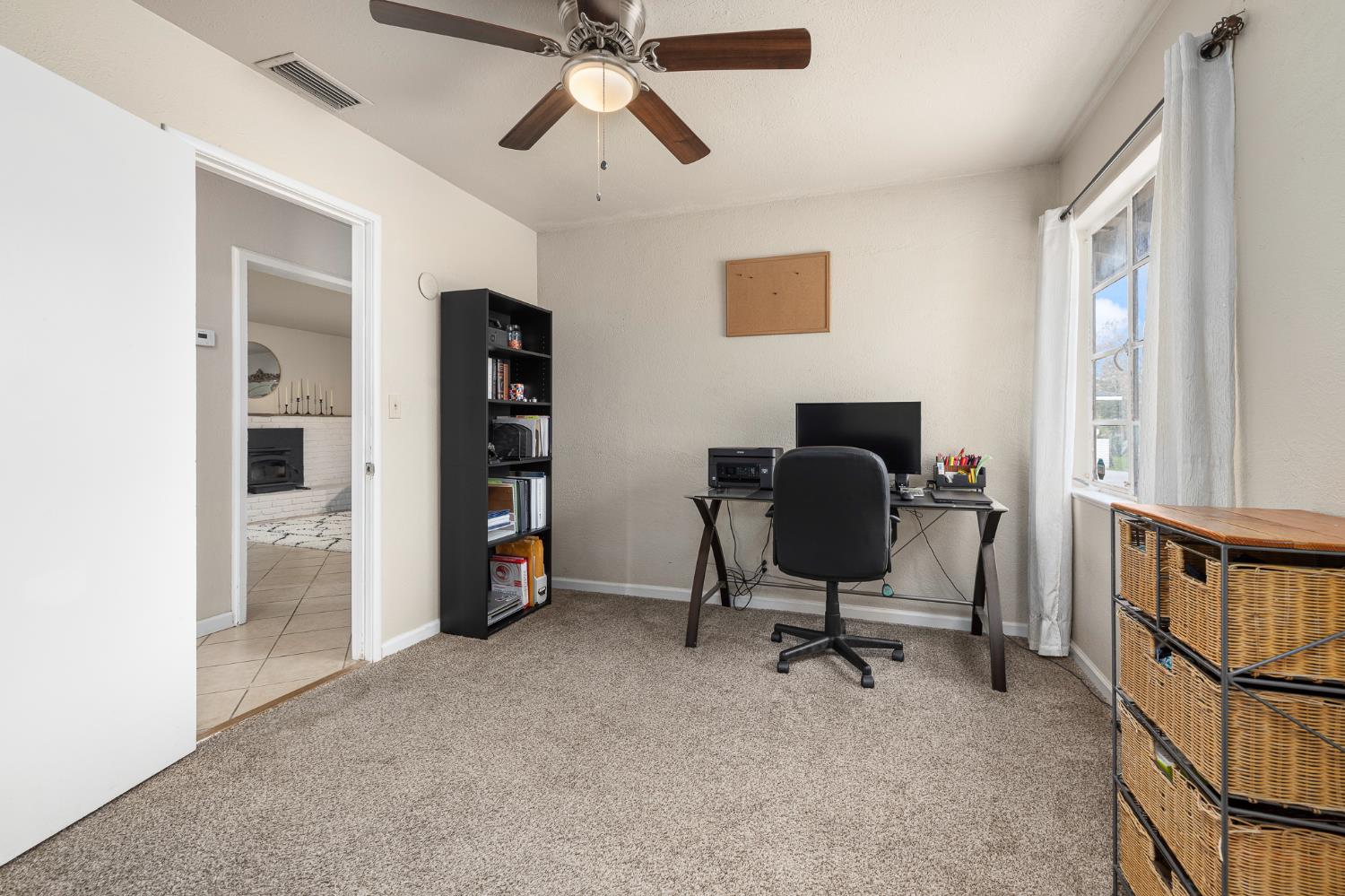3310 East Hampton Way Fresno, CA 93726 - Photo 12 of 20 a view of a workspace with furniture and a window
